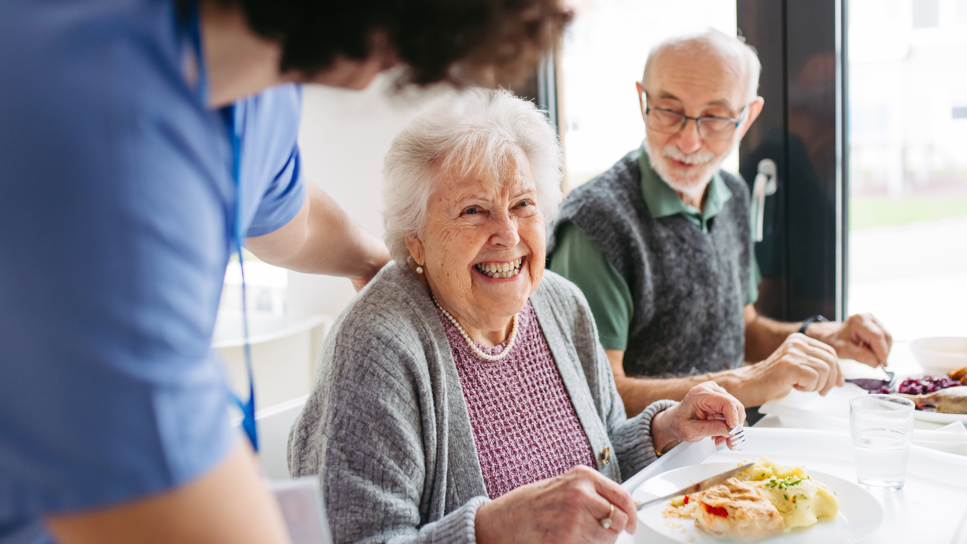 seniors socializing in adult day support center activity room