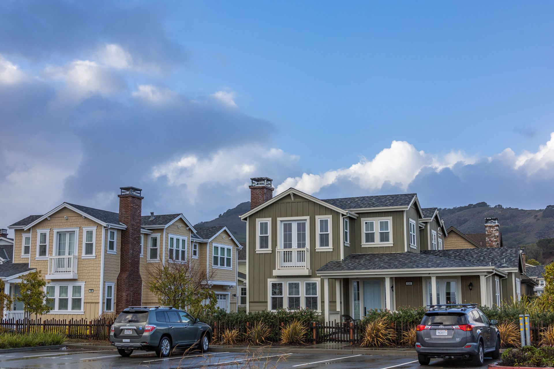 Row of Maryland-style suburban homes under a blue sky