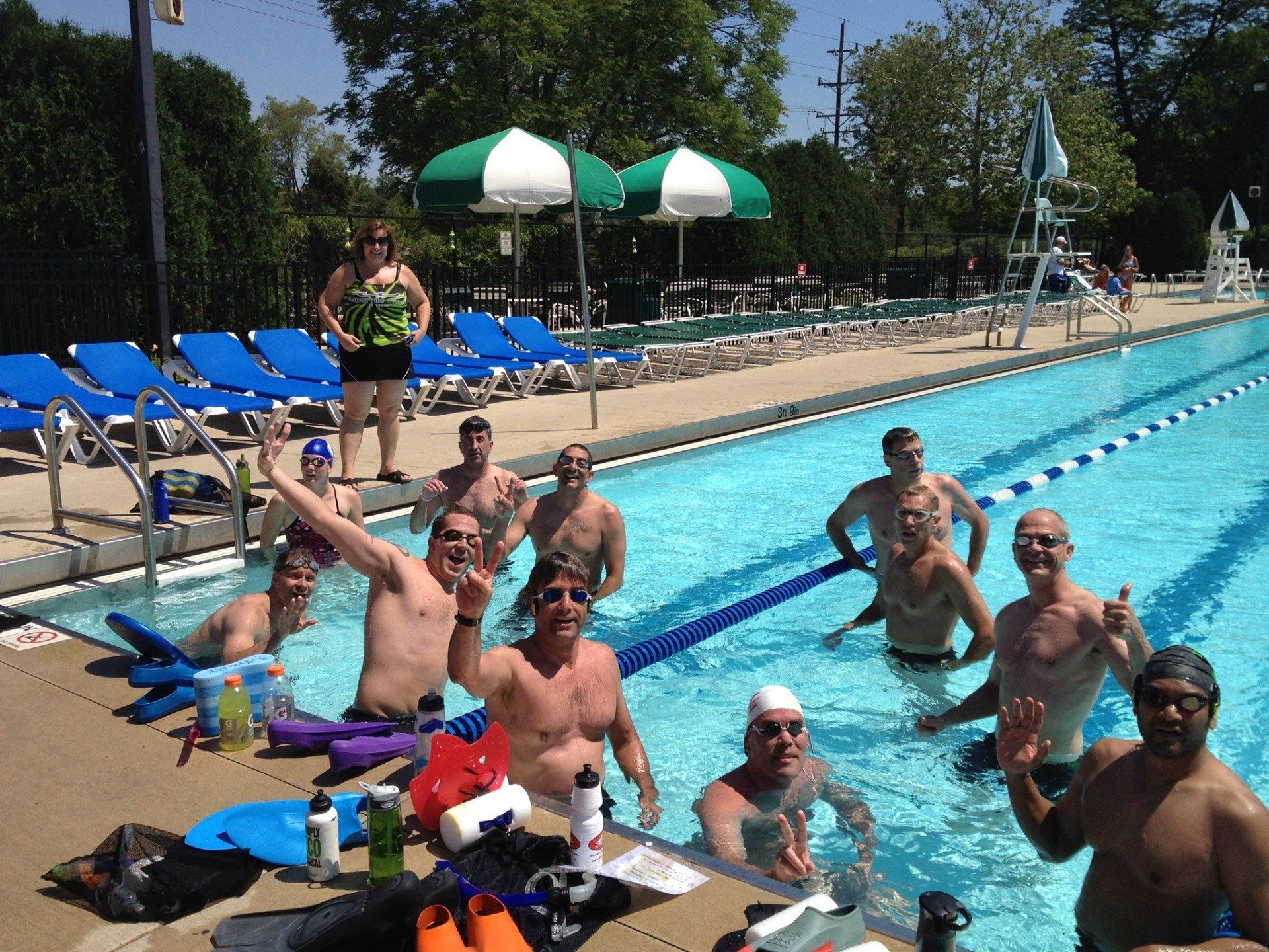 A group of men are posing for a picture in a swimming pool
