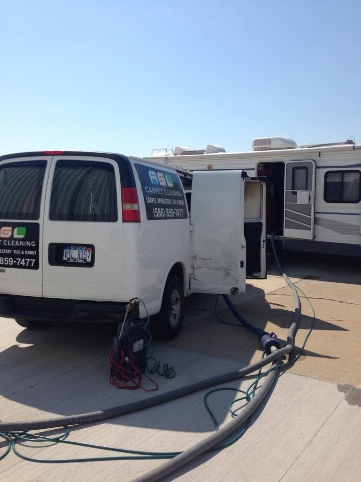 A.G.L Carpet Cleaning van and equipment on a sunny lot