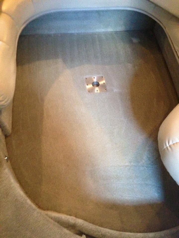Empty beige sink with a chrome drain at the center
