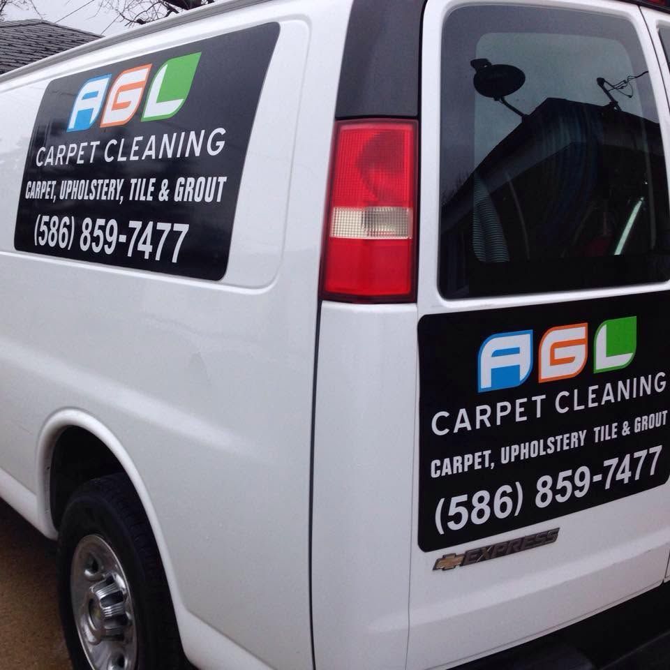 White A.G.L Carpet Cleaning van with logo and phone number on side and rear