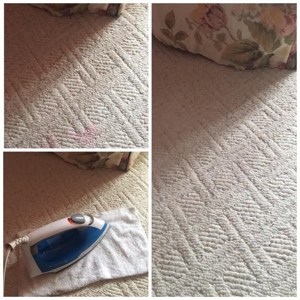 Iron on carpet near floral cushion, showing a blue-and-white steam iron warming the rug.
