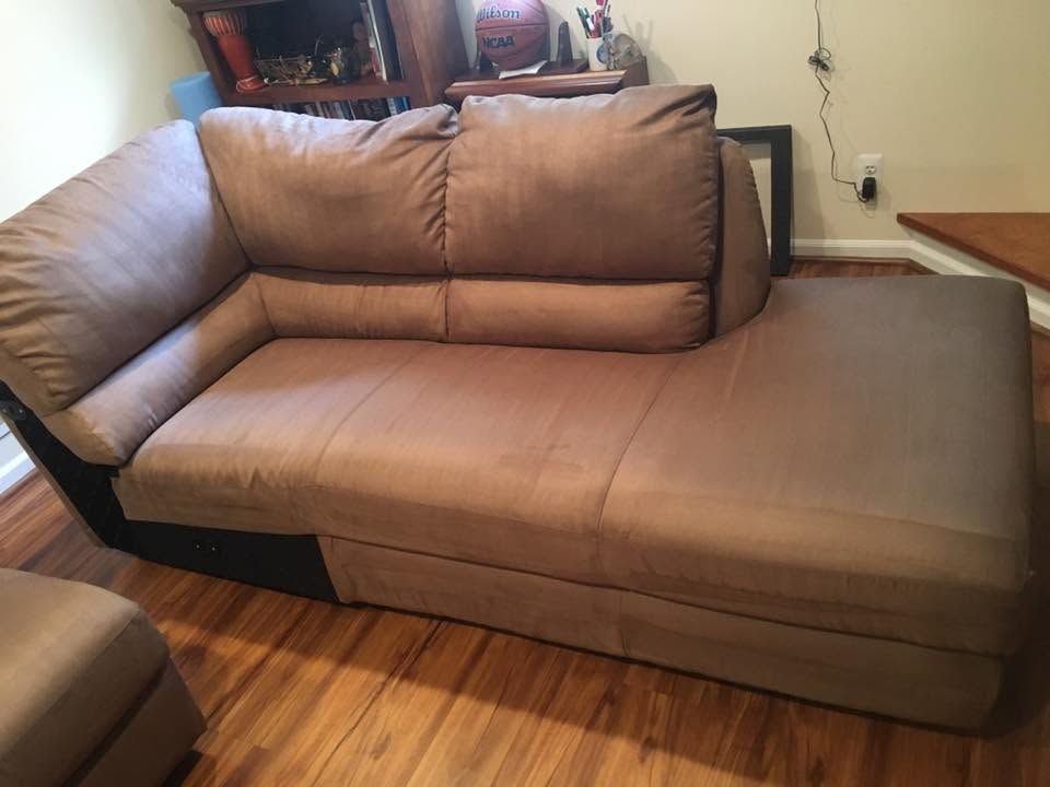 Brown sectional sofa with chaise in a living room on hardwood floor