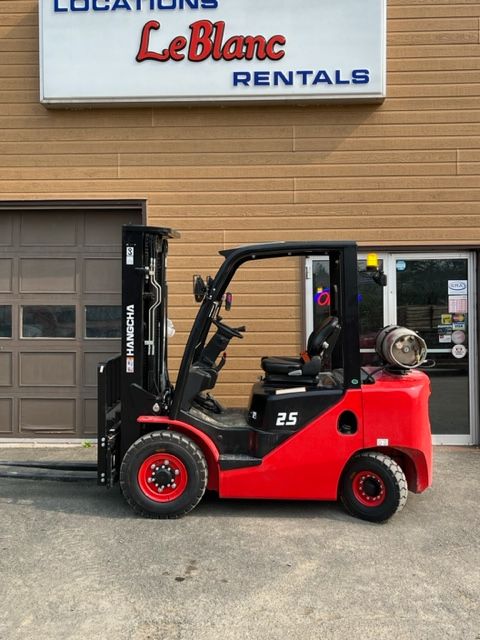 Red and black forklift outside LeBlanc Rentals building.