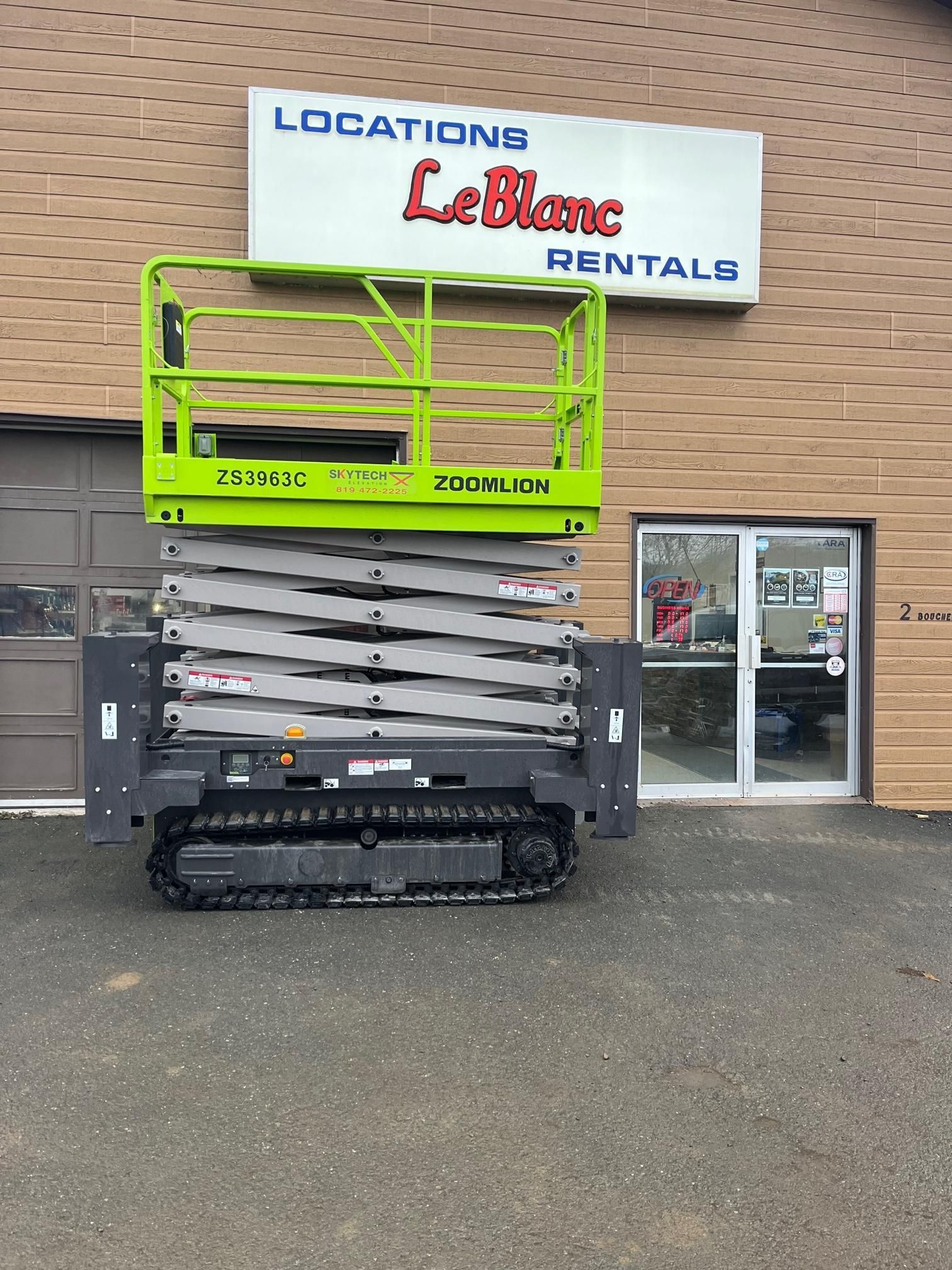 Green and gray track lift in front of 