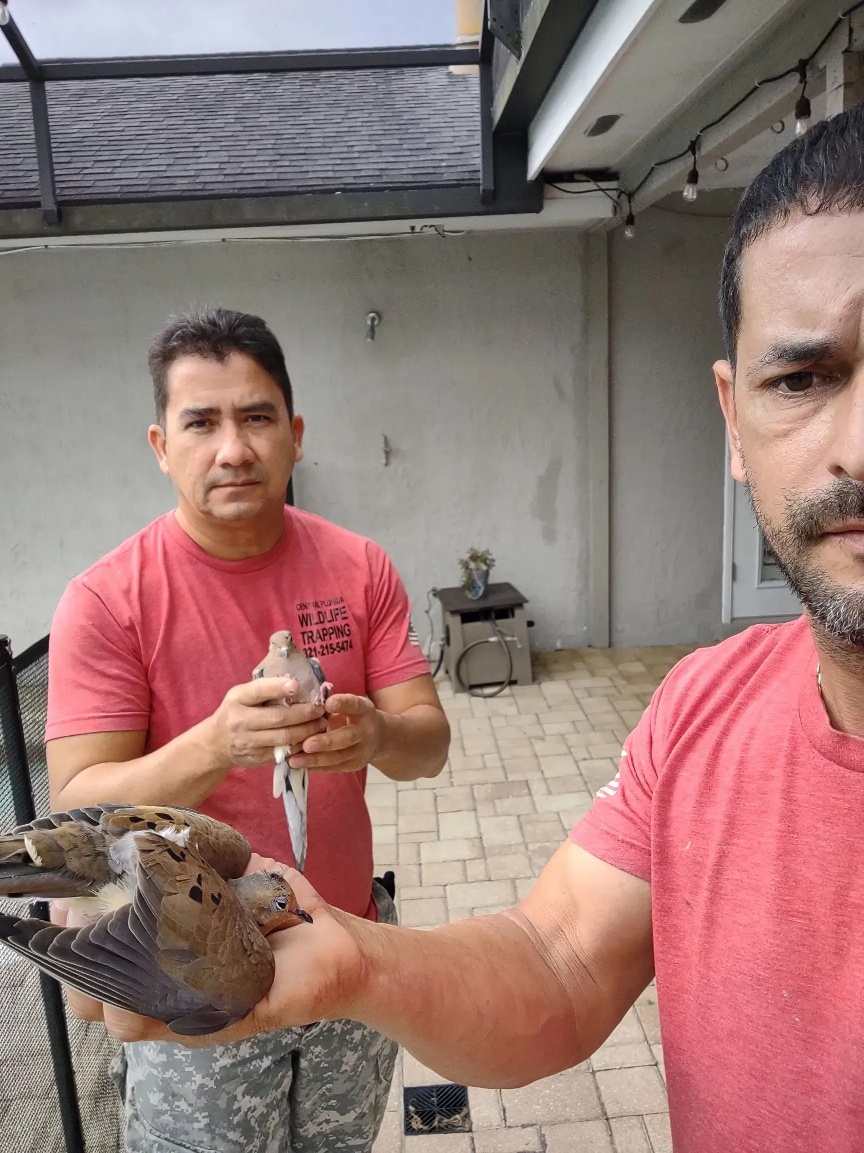 Angel Cortes and Edgar Nunez with a bird