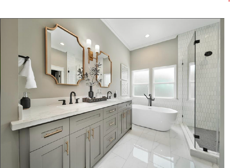 Bright modern bathroom with double vanity, freestanding tub, glass shower, and large windows.