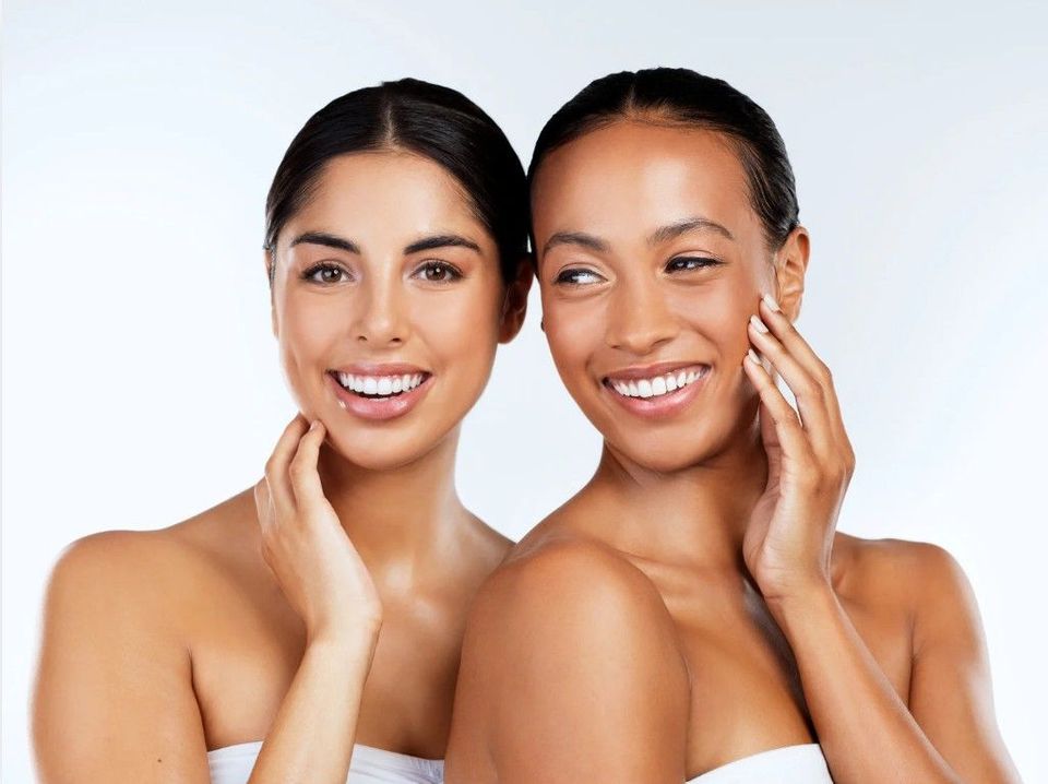 Two smiling clients after aesthetic treatments at Signature Aesthetics in Nottingham
