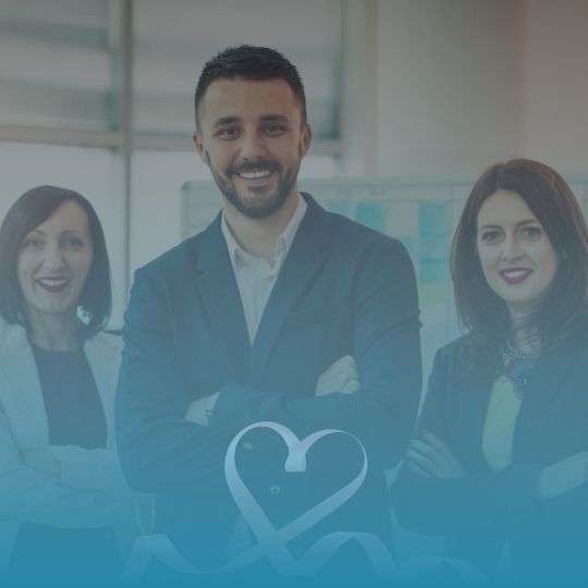 A man and two women are standing next to each other with a heart in the middle.