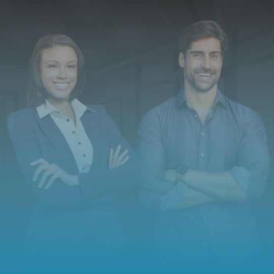 A man and a woman are standing next to each other with their arms crossed.