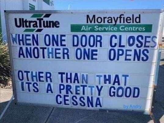 Blue-and-white sign reading, “When one door closes another opens… it’s a pretty good Cessna.”