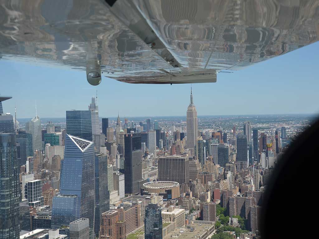 Aerial city skyline with the Empire State Building, seen from an airplane window