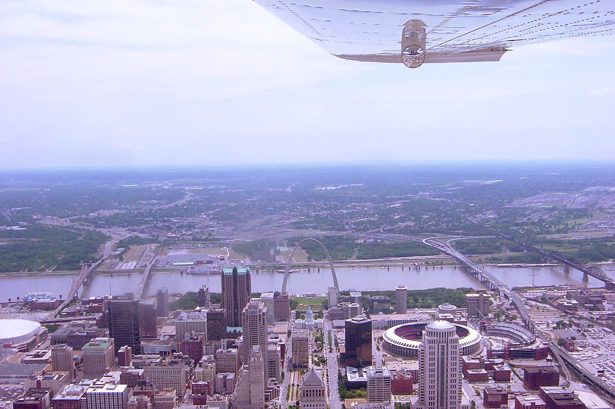 Aerial view of a city skyline and river, seen from an airplane window above