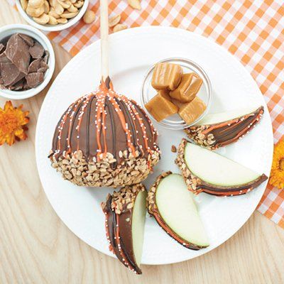Caramel-apple dessert on a white plate with pecans, sliced apple, caramel pieces, and chocolate drizzle