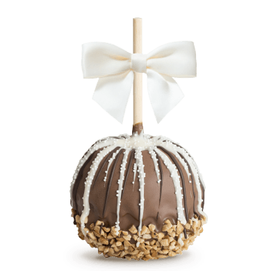 Caramel apple with white drizzle, crushed nuts, and a white bow on a stick