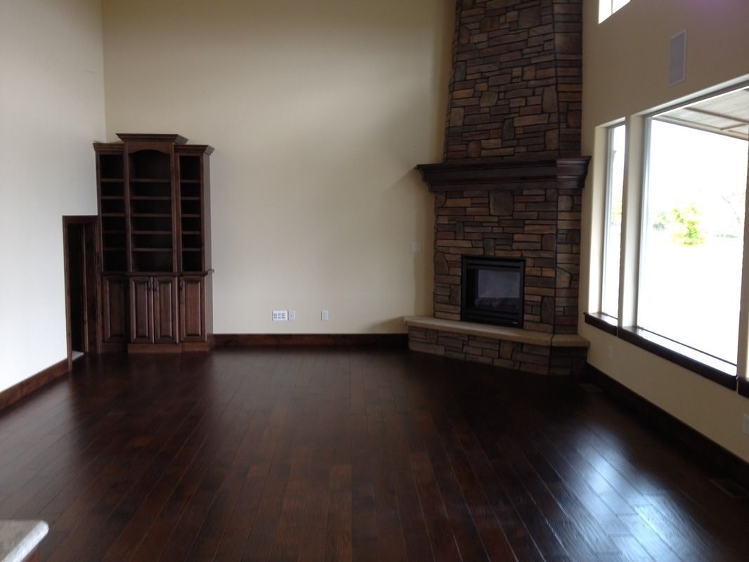 Dark hardwood floors in a spacious room