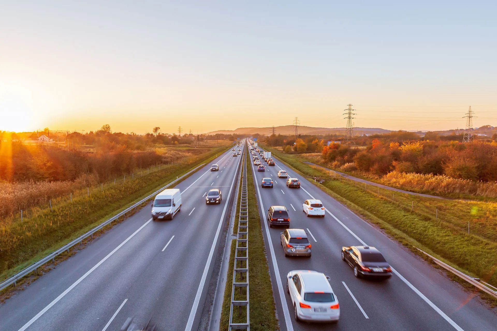 A highway with cars driving down it at sunset - Patterson Brothers Automotive
