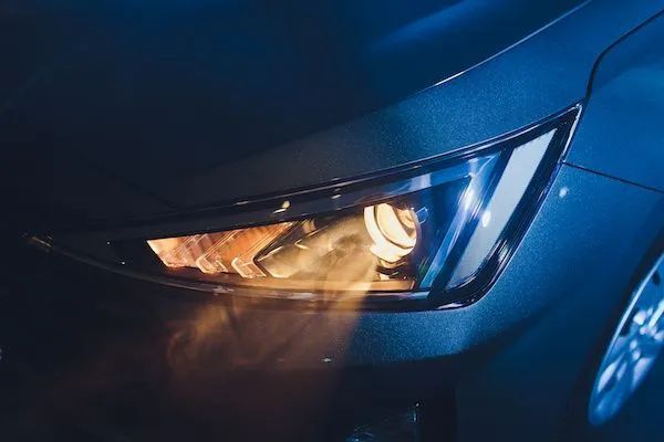 A close up of a car headlight at night - Patterson Brothers Automotive