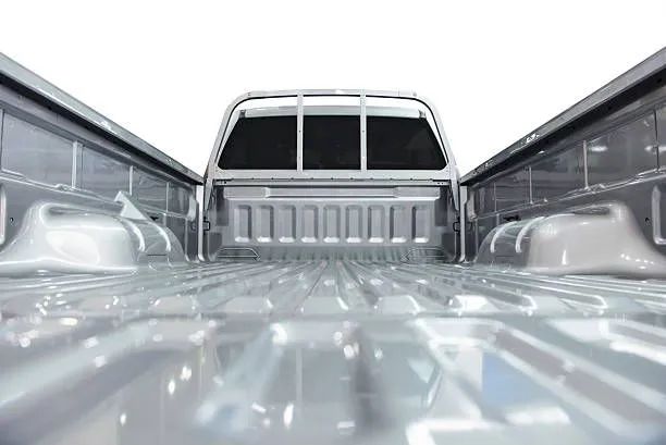 A close up of the back of an empty truck bed on a white background - Patterson Brothers Automotive