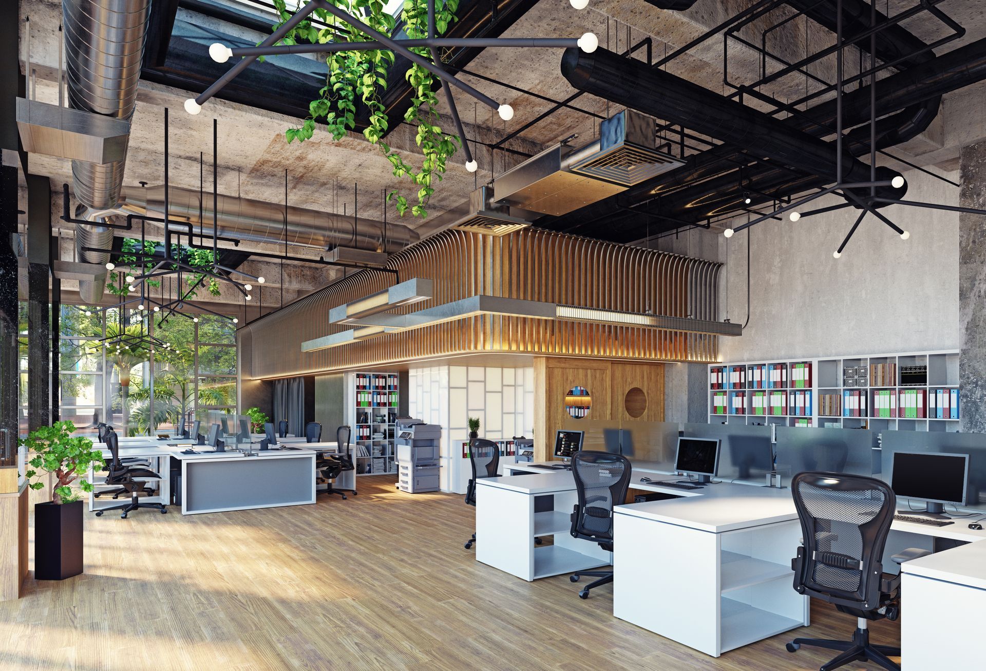 Modern open-plan office with desks, black chairs, wood floors, hanging plants, and exposed industrial ceiling