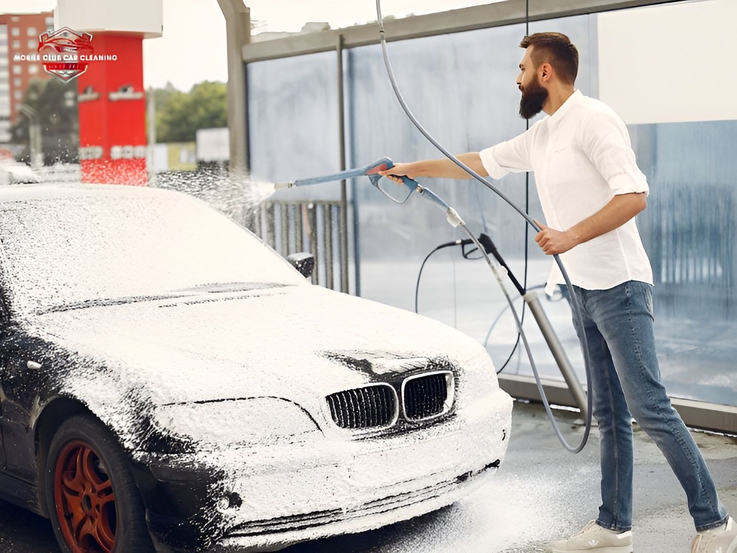 Man Washing a Black Car With Soapy Water at a Car Wash — Mobile Club Cars Cairns in Earlville, QLD