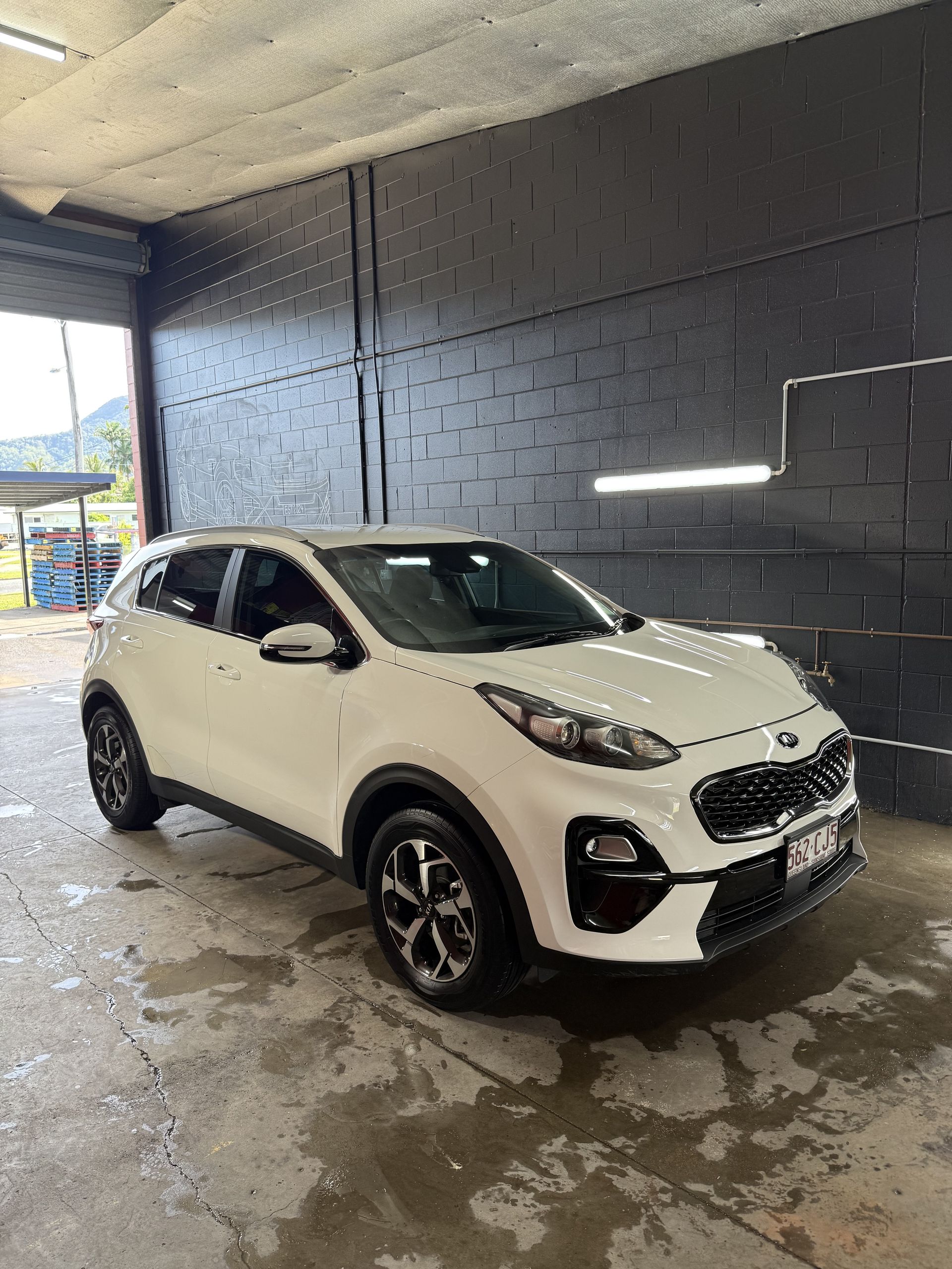 White KIA Sportage SUV Parked Inside a Garage — Mobile Club Cars Cairns in Earlville, QLD