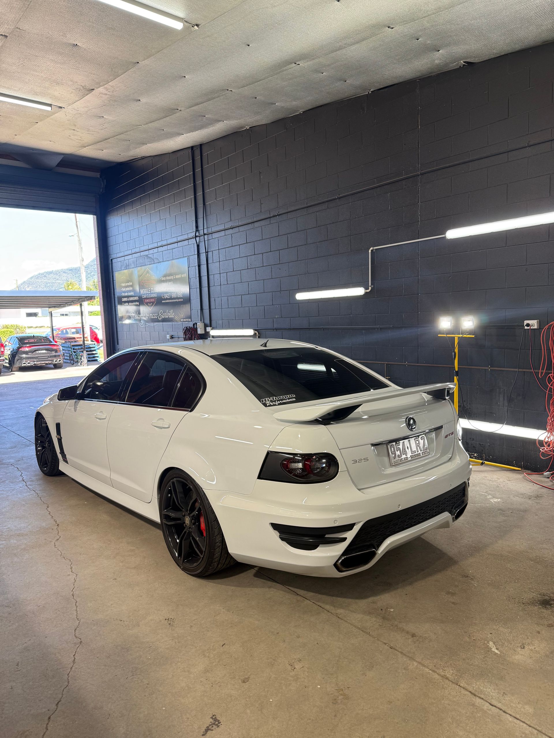 White Sports Sedan with Black Rims Parked in A Covered Garage — Mobile Club Cars Cairns in Earlville, QLD