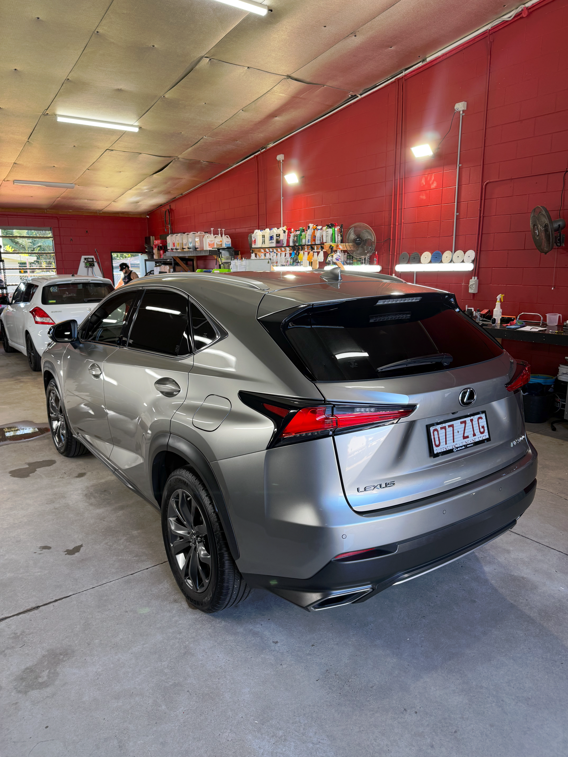 Silver SUV in a Red Garage Bay, Viewed from The Rear with Shop Equipment — Mobile Club Cars Cairns in Earlville, QLD