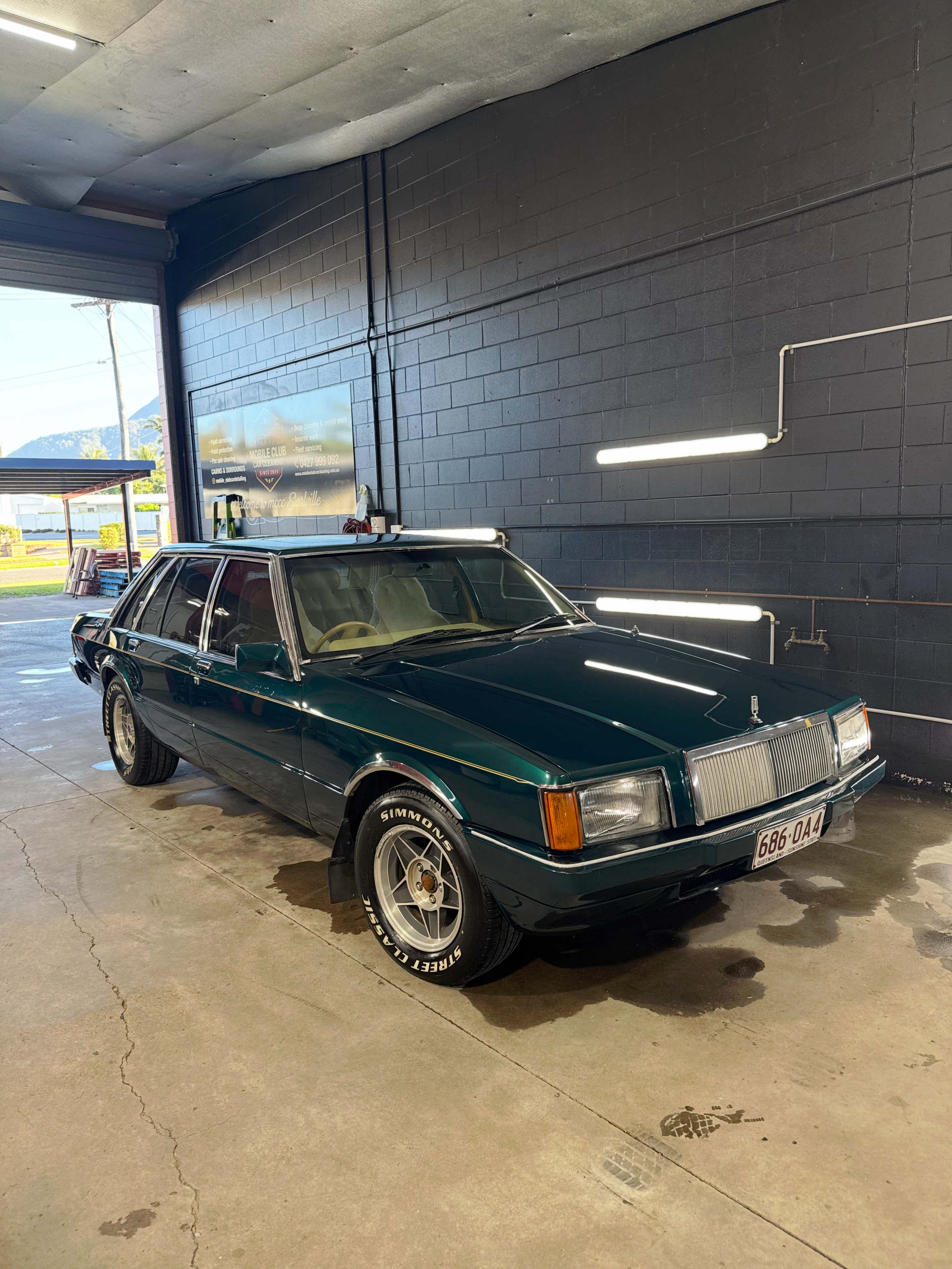Dark Green Vintage Sedan Parked Inside a Garage — Mobile Club Cars Cairns in Earlville, QLD