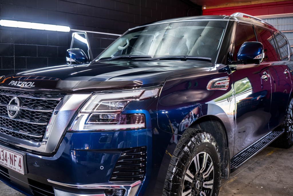 Blue Cadillac SUV Parked Indoors Under Showroom Lights — Mobile Club Cars Cairns in Earlville, QLD