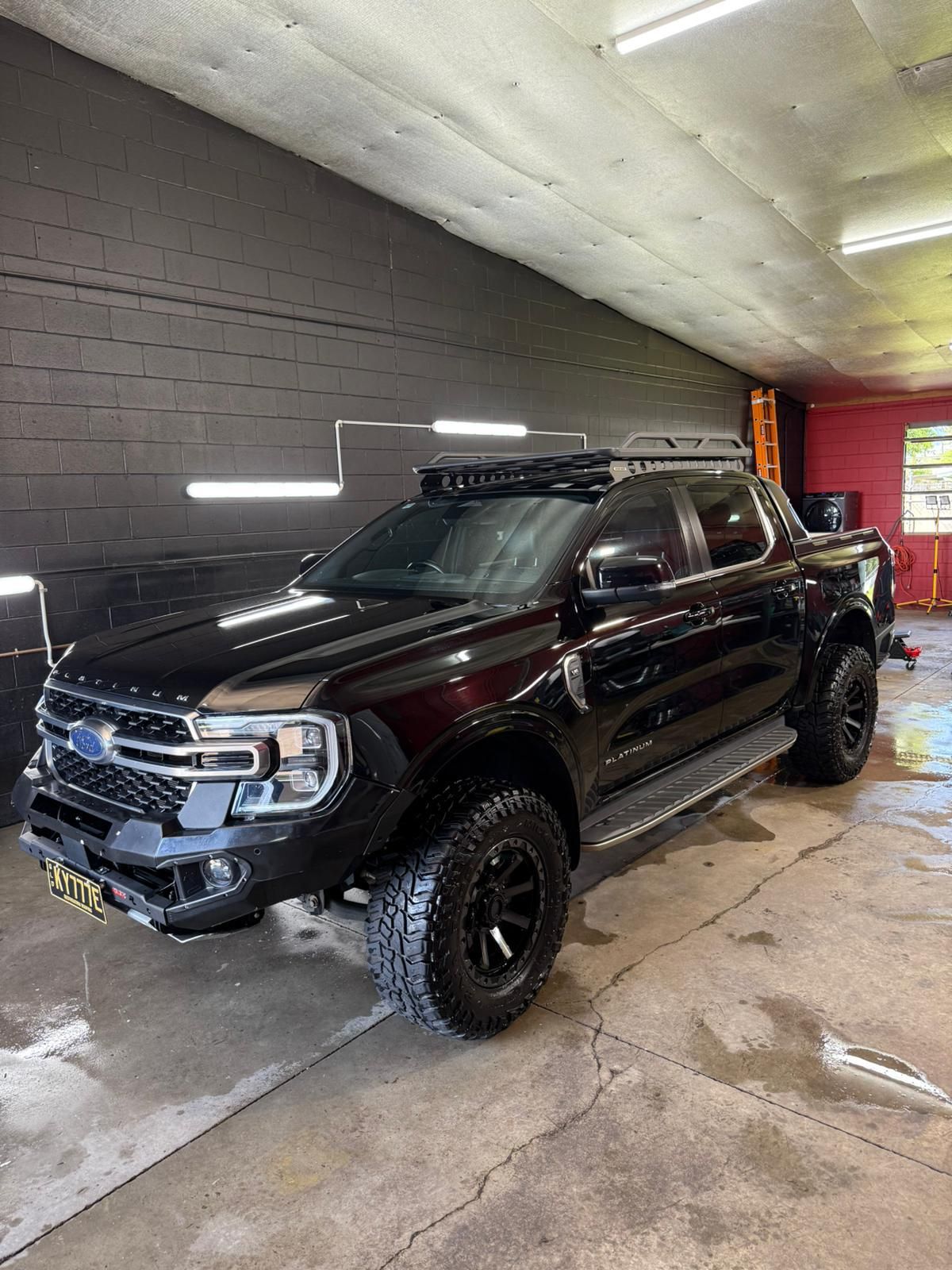Black Pickup Truck with Roof Rack, Modified Front Bumper, and Off-Road Tires — Mobile Club Cars Cairns in Earlville, QLD