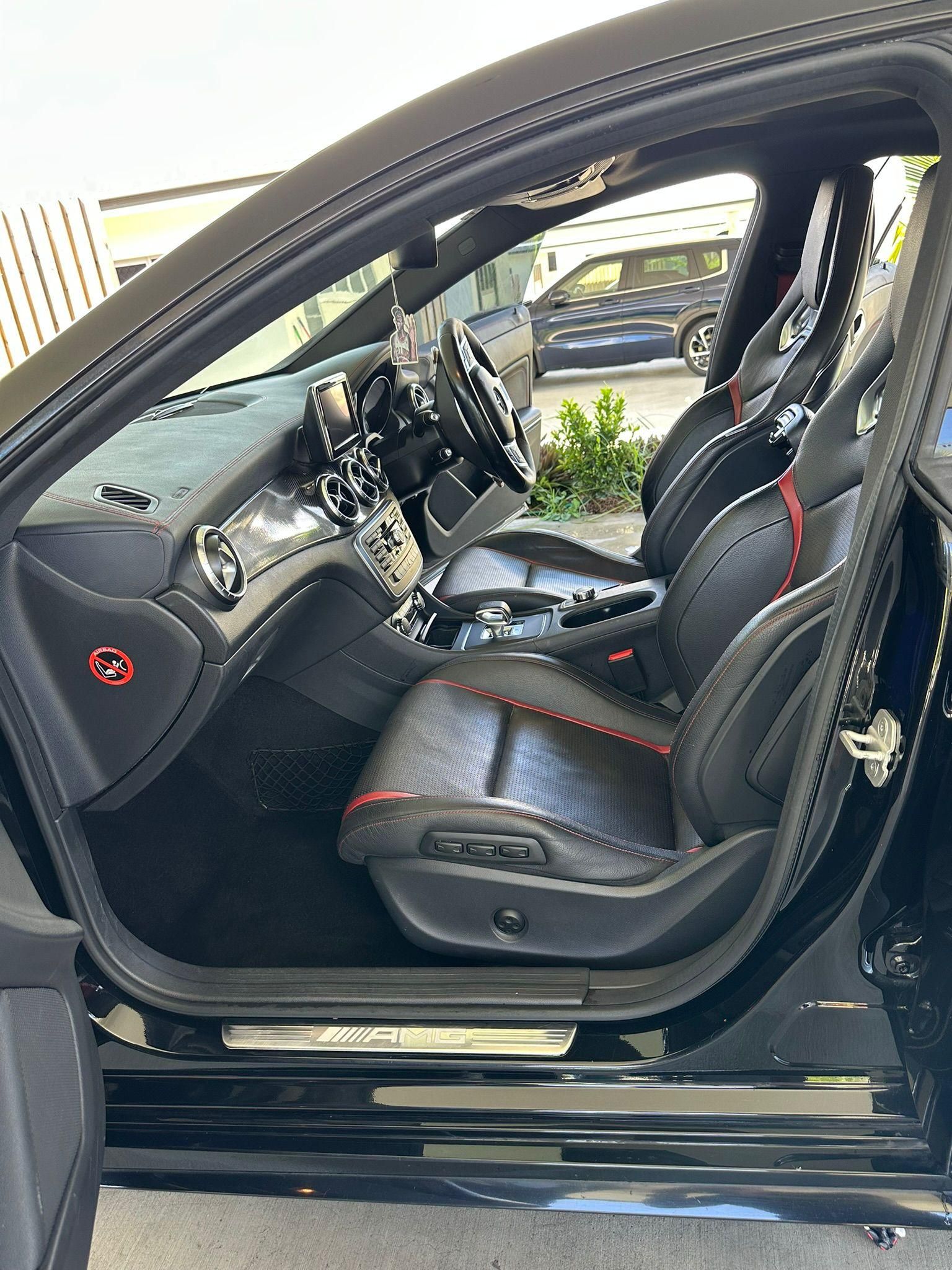 Black Car Interior with Black and Red Seats, Open Door — Mobile Club Cars Cairns in Earlville, QLD