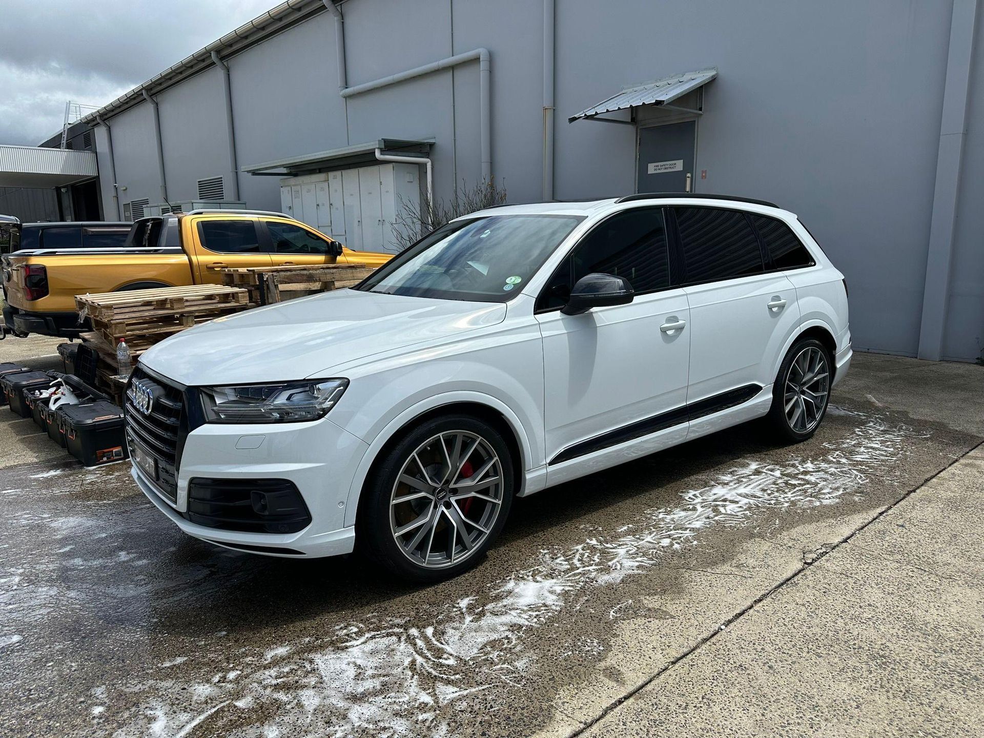 White Audi Q7 SUV Parked on Concrete Outside a Building — Mobile Club Cars Cairns in Earlville, QLD