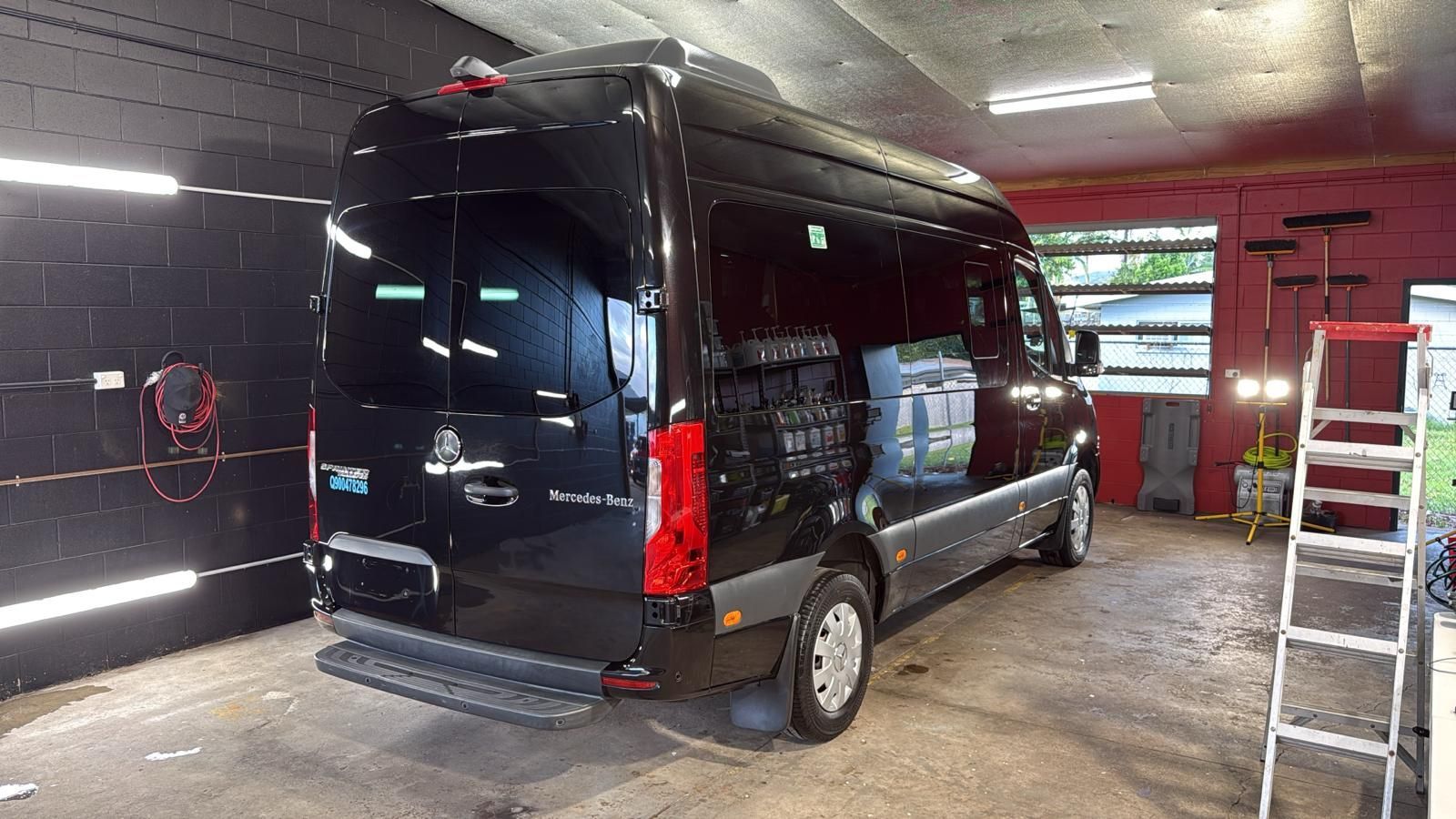 A Shiny Black Sprinter Van Parked Inside a Workshop — Mobile Club Cars Cairns in Earlville, QLD