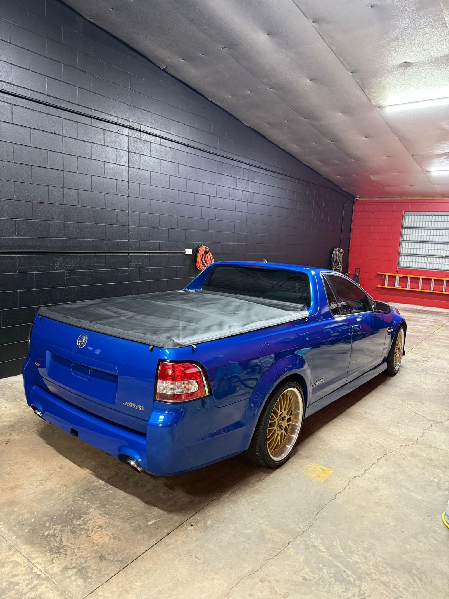Blue Utility Vehicle with Gold Rims Parked in A Garage — Mobile Club Cars Cairns in Earlville, QLD
