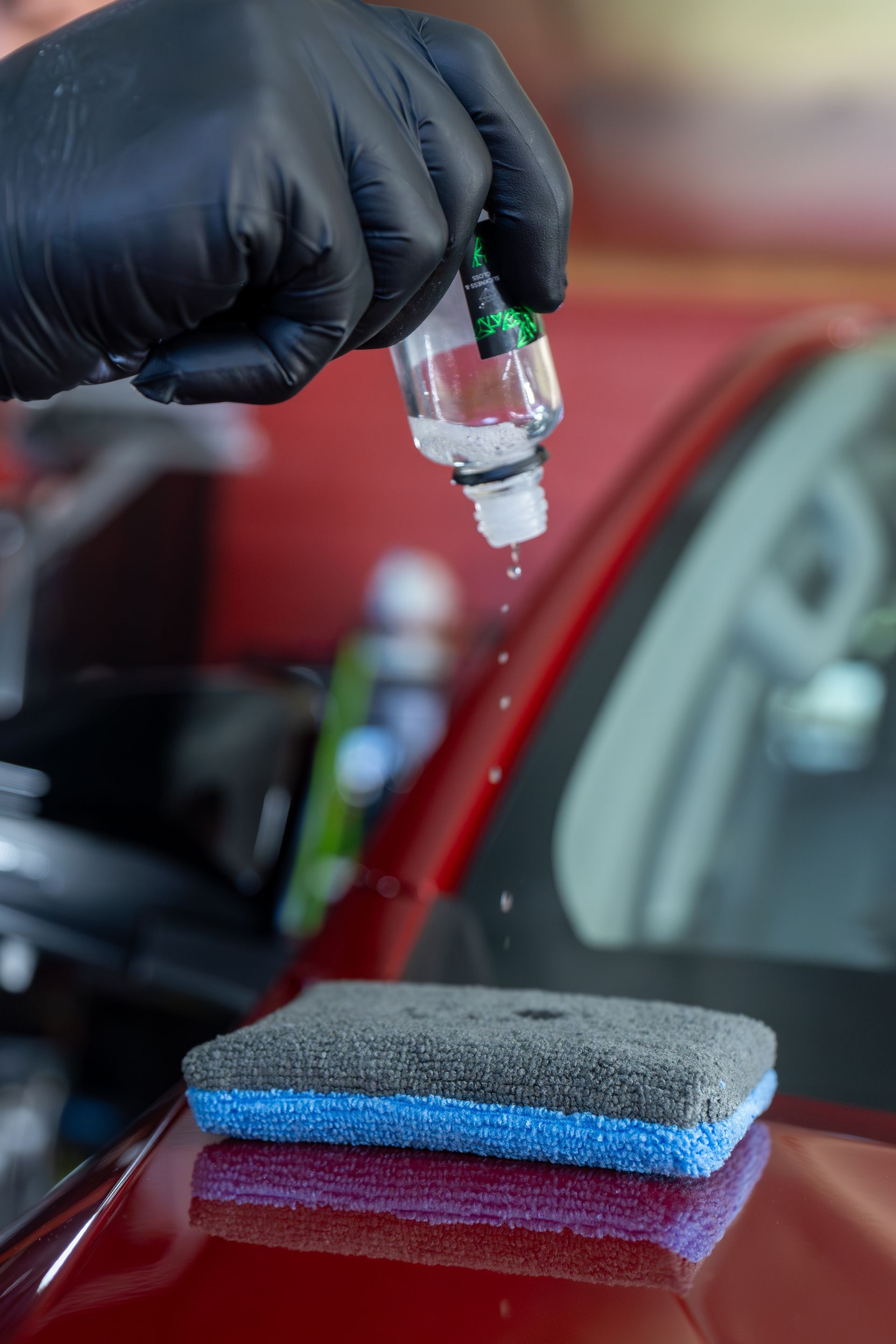 Gloved Hand Applying Paint Polish to A Red Car — Mobile Club Cars Cairns in Earlville, QLD