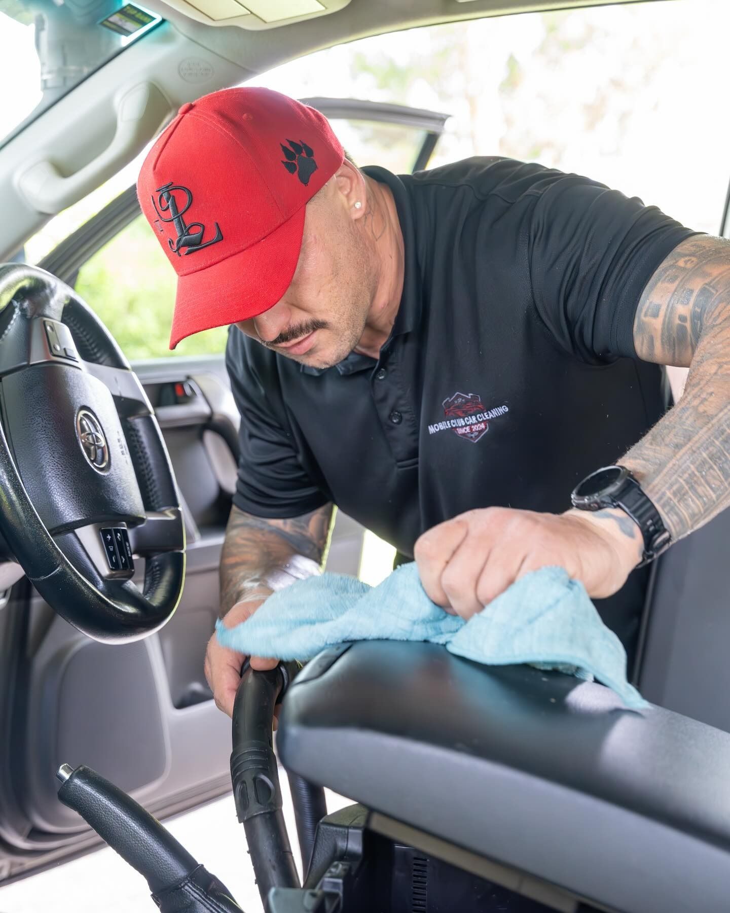Man Cleaning Interior of a Car With a Blue Cloth — Mobile Club Cars Cairns in Earlville, QLD