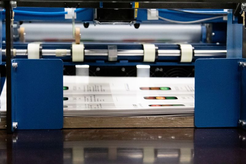 A machine that is printing a piece of paper