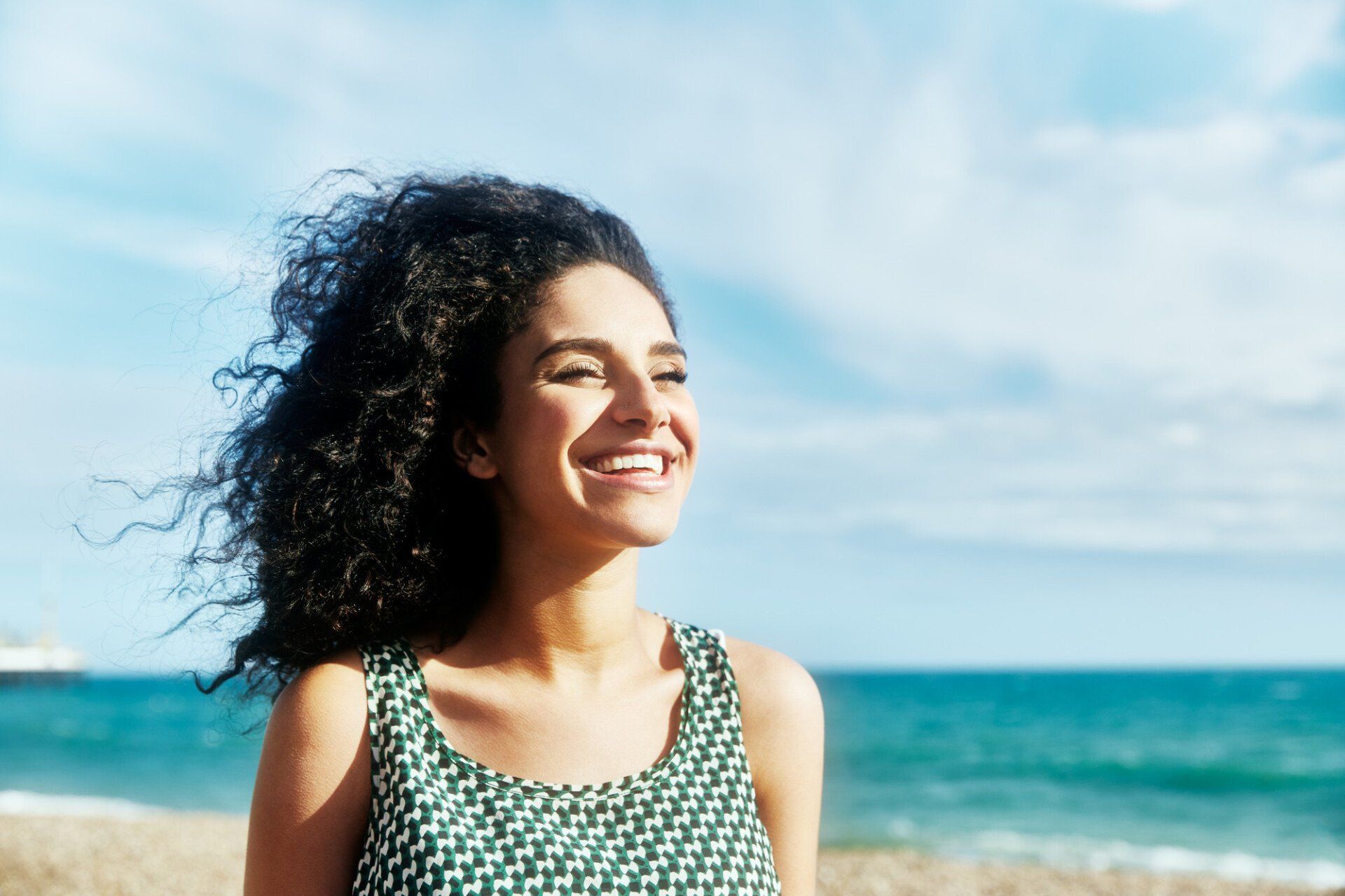 Cropped shot of a young woman cycling on the beach