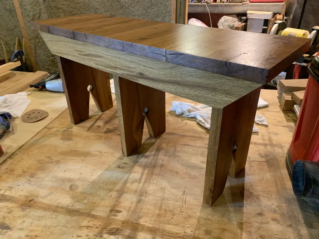 A wooden table is sitting on top of a wooden floor.