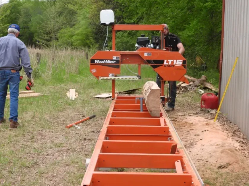 A man is standing next to a machine that says lt15