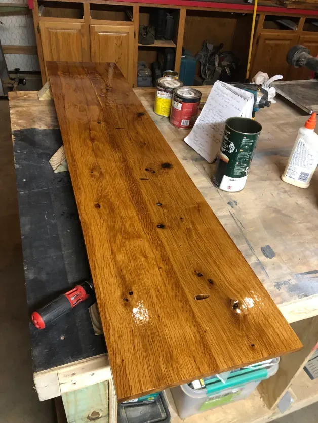 A piece of wood is sitting on top of a wooden table.