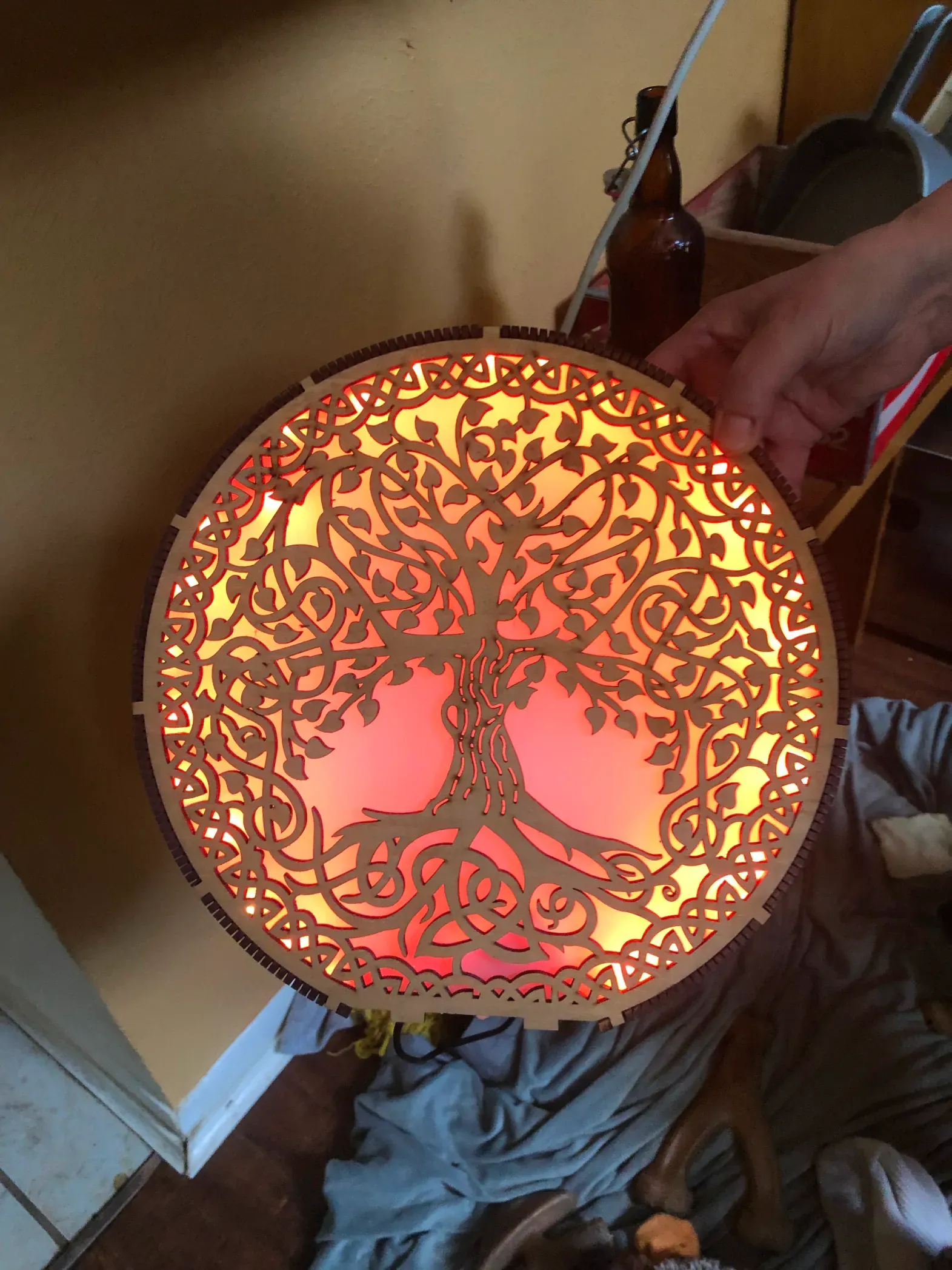 A wooden plate with a tree of life design on it