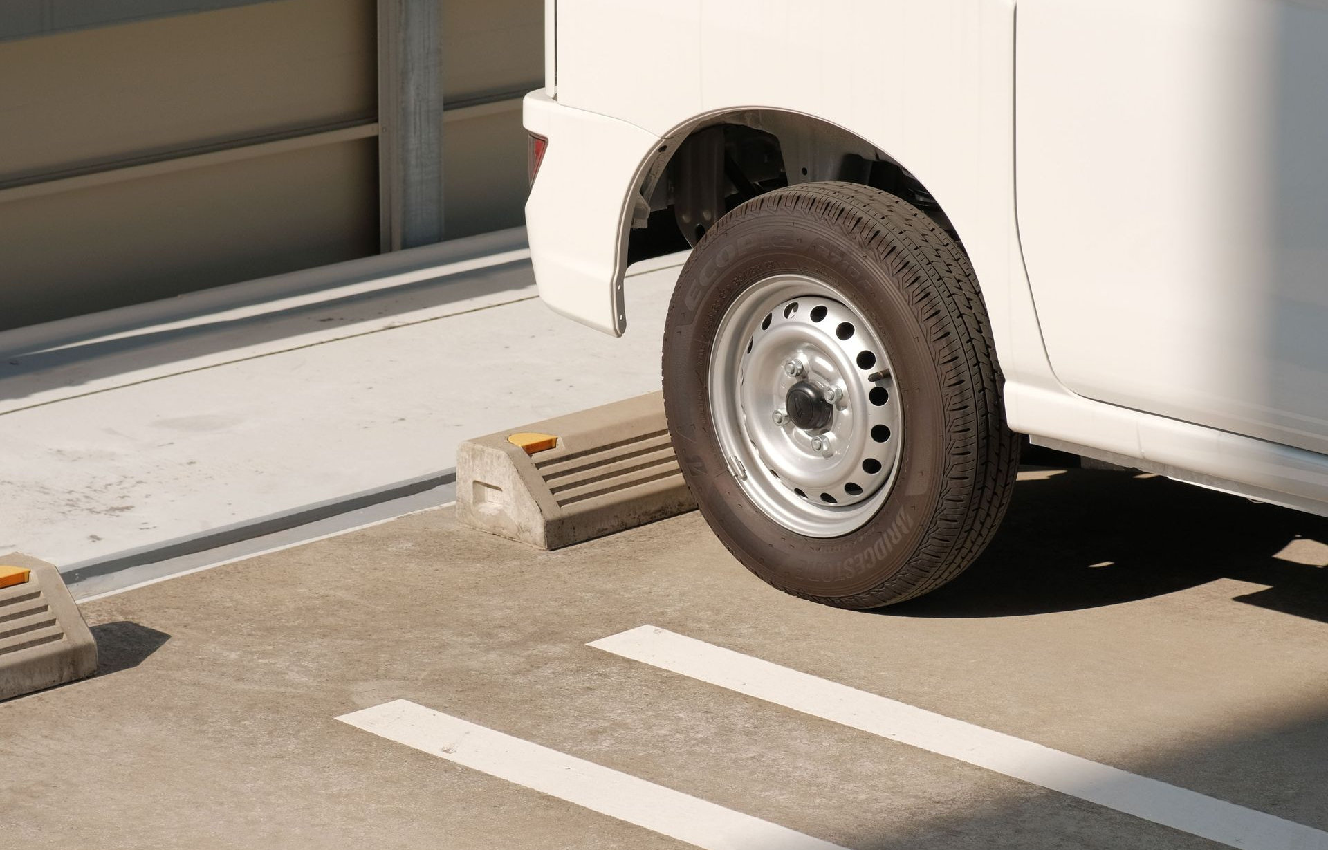 White Van Parked in Front of Wheel Stop in Houston, TX