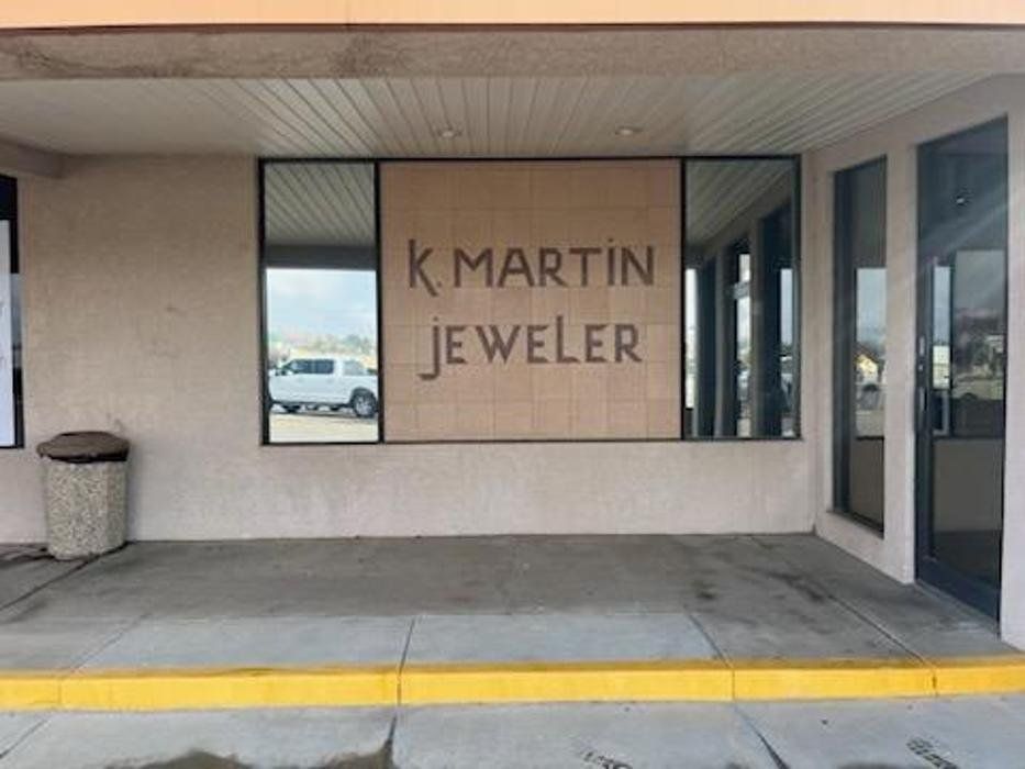 A store front with a sign that says k martin jeweler