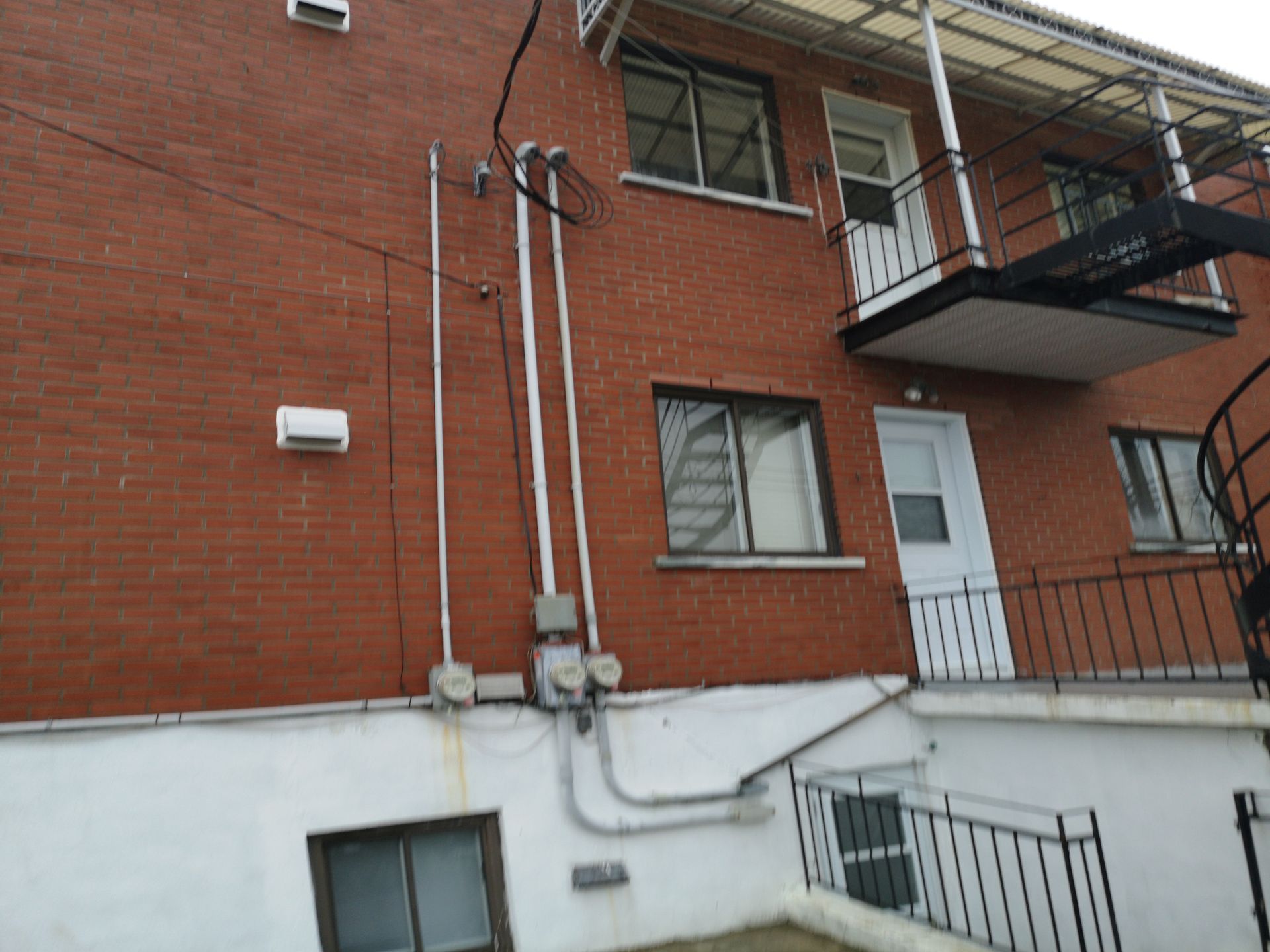 Un bâtiment en brique avec balcon et escaliers