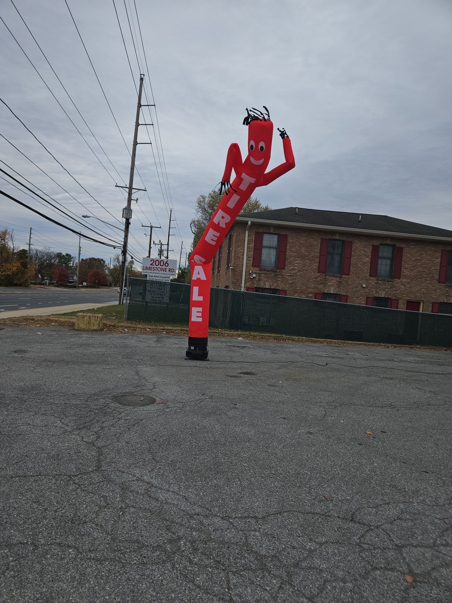 A red air dancer with the word sale on it