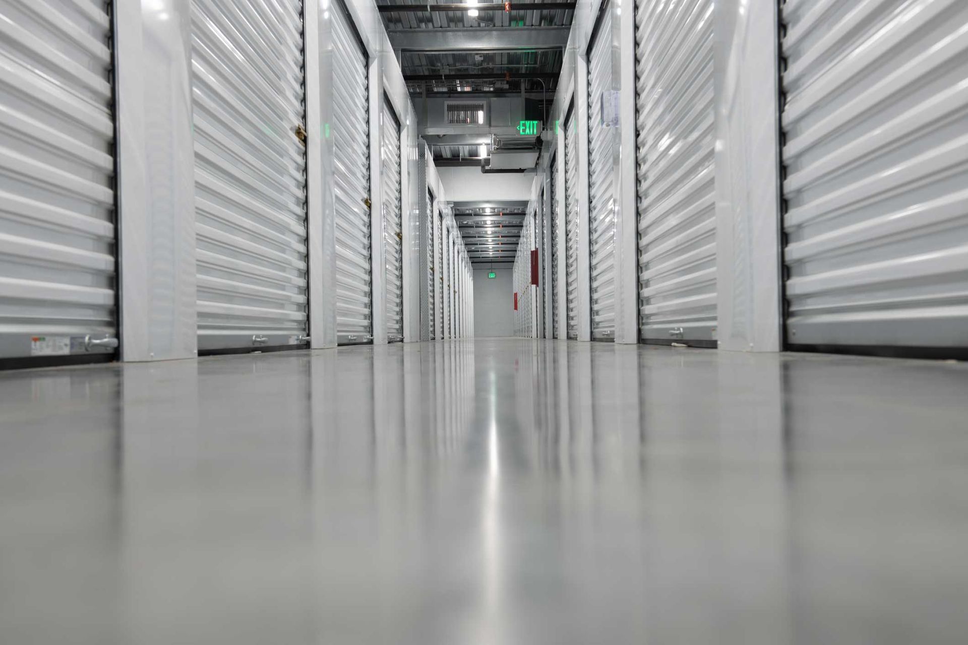 Climate-controlled units hallway with clean indoor storage doors and polished concrete floors.