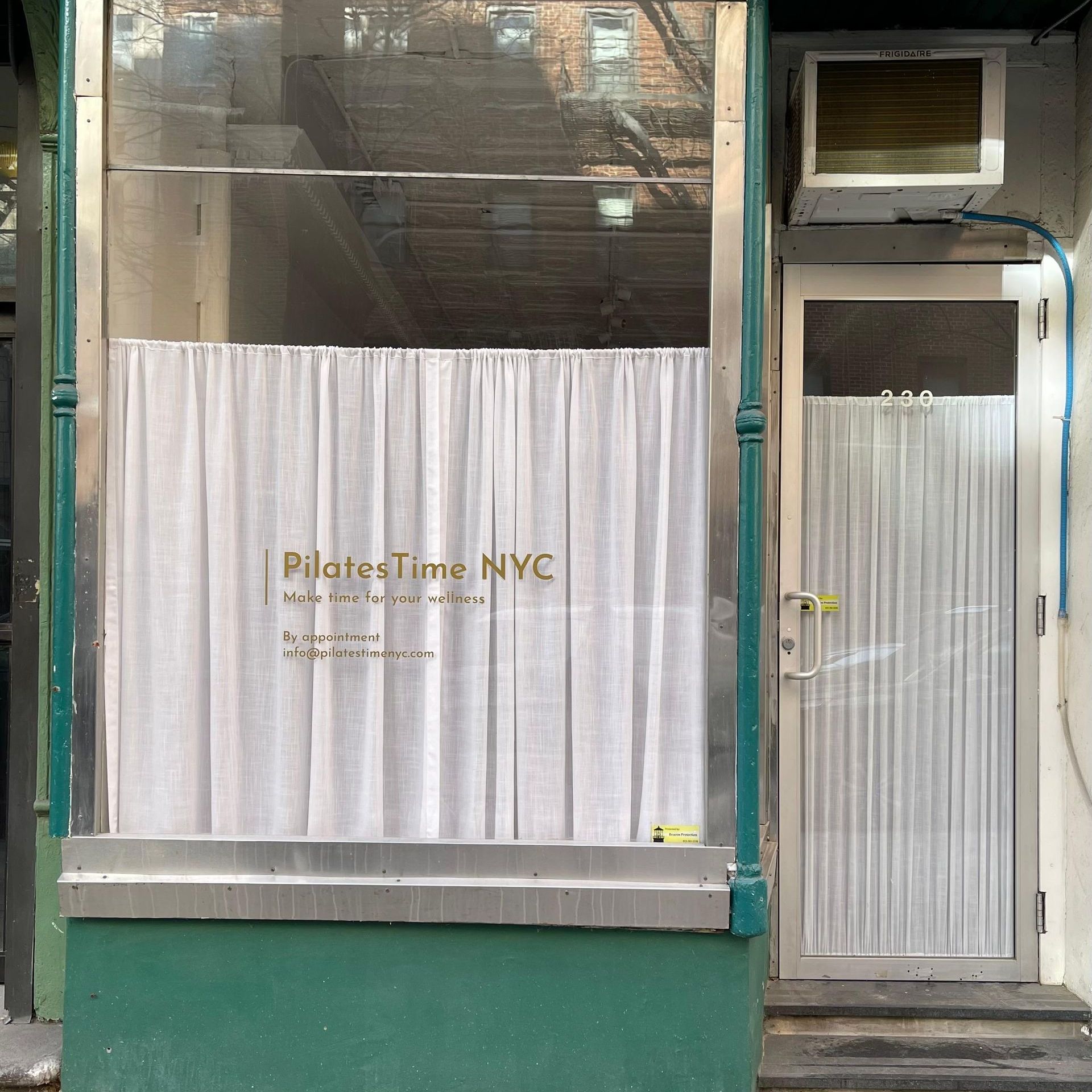 A store front with a sign that says pilates time nyc